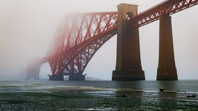 Timelapse of the Forth Bridge enshrouded in mist, a cantilever railway bridge across the Firth of Forth and a symbol of Scotland, UK
