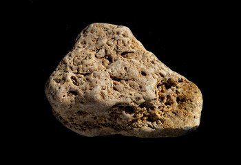 Limestone mineral nugget from Crimea isolated on black background. For geology or mineralogy websites, stone collection catalog, Natural Science museum wall charts or posters