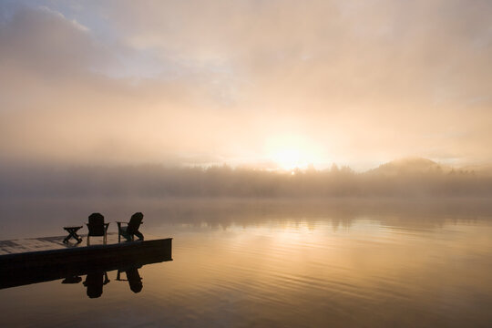 USA, New York State, Adirondack State Park, Morning mist on lake in Adirondack Mountains