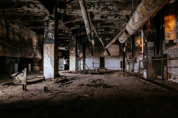 Burnt and ruined interior of industrial building after fire. Consequences of war, fire or other disaster