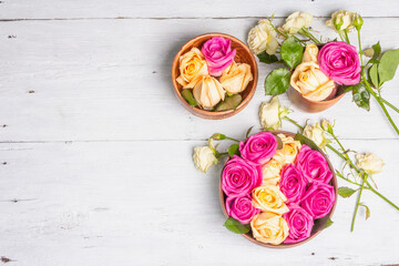 Obraz na płótnie Canvas Composition of fresh multicolored roses in kitchen utensil