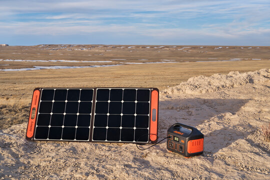 Jackery Explorer 500, 518Wh Lithium Portable Power Station, Is Being Charged By A Solar Panel In A Remote Location In Pawnee National Grassland, Early Spring Scenery.