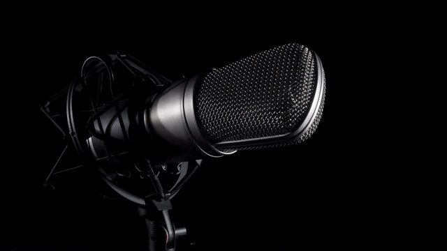 Professional studio microphone on an anti vibration stand, being side lit
