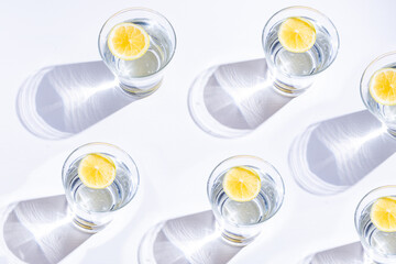 Pattern of glass with lemonade, illuminated by strong summer sun. Top View