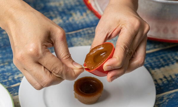 Making Malaysian Dessert Kuih Lompang Or Sweet Steamed Cakes.