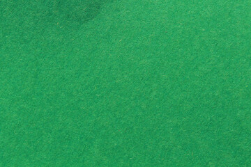 close up aka macro shot of green construction paper, showing texture, paper fibers, flaws, and...