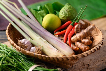Thai food ingredients, Spices and herbs for cooking in a bamboo basket on wooden, Organic vegetables