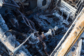 Burned down car, abstract background, selective focus. The situation of protests in the world.