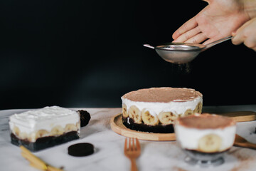Banoffee cake with bananas, whipped cream, chocolate, caramel, coffee and toffee in cafe restaurant