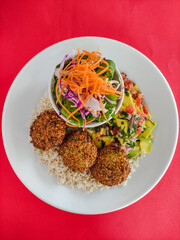 falafel and guacamole dish top view red background 