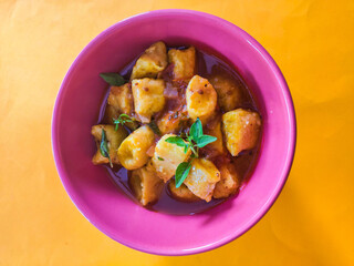 gnocchi pink bowl top view orange background 