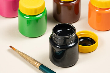open gouache paint glass with other tubes in the background