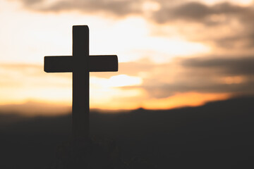 Religious concepts. Christian wooden cross on a background with dramatic lighting,  Jesus Christ cross, Easter, resurrection concept. Christianity, Religion copyspace background.