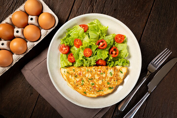 Omelet with cheese and lettuce and tomato salad.