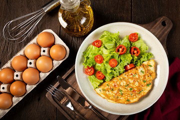 Omelet with cheese and lettuce and tomato salad.