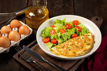 Omelet with cheese and lettuce and tomato salad.