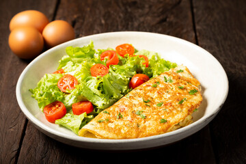Omelet with cheese and lettuce and tomato salad.