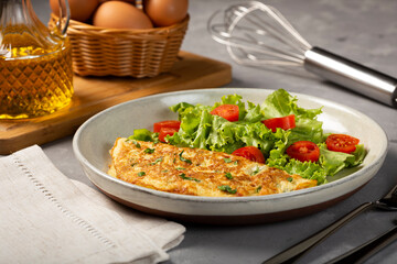 Omelet with cheese and lettuce and tomato salad.