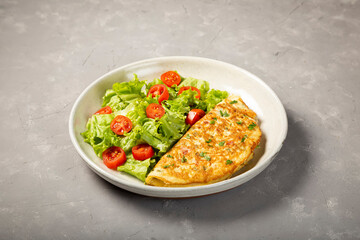Omelet with cheese and lettuce and tomato salad.