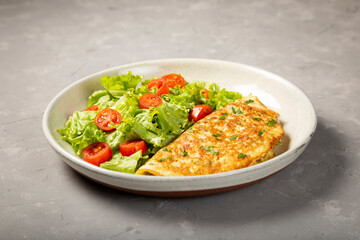 Omelet with cheese and lettuce and tomato salad.