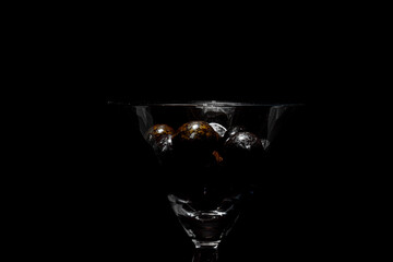 glass with chocolate balls on a dark background