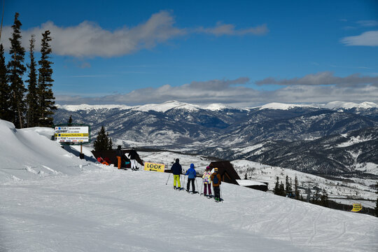group of skiers on the top of the slope. Breckenridge ski resort in winter time with snow in the Colorado Rocky Mountains.