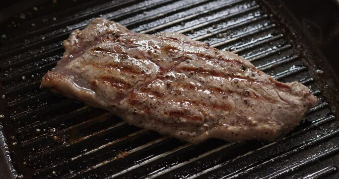 Close up Grilled Steak in frying pan, Ingredients for cooking, Front view food concept.