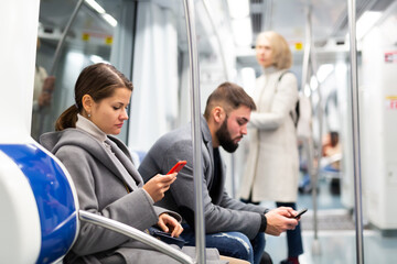 Fototapeta na wymiar People browsing in smartphone in subway. High quality photo