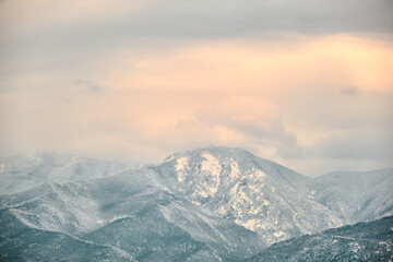 Ulu mountain (uludag) in bursa Turkey during winter and misty and foggy view of mountain from city center and many snow peak of huge moutain.