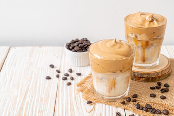 Obraz na płótnie Canvas Iced Dalgona Coffee, a trendy fluffy creamy whipped coffee