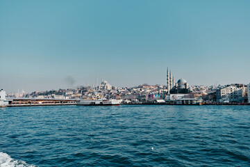 Fototapeta premium Turkey istanbul 03.03.2021. Yeni Cami mosque in istanbul turkey during morning with seagulls. Galata bridge corner and pedestrian ferry in istanbul bosphorus early in the morning.