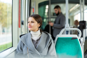 Pretty woman in public land transport. High quality photo