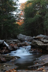 autumn waterfall flowing through mountain creek