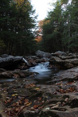 autumn waterfall flowing through mountain creek