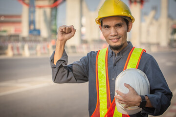 Engineer holding helmet on site Road construction For the development of modern transportation systems, Technician worker hold hard hat safety first