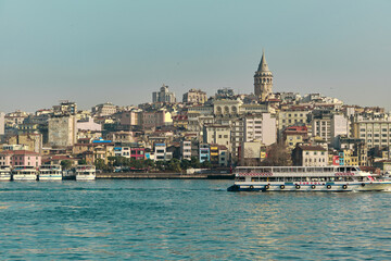 Fototapeta premium Turkey istanbul 04.03.2021. Famous galata tower of istanbul taken photo from istanbul bosporus. it is established by genoese sailors for watching of bosporus of constantinople.