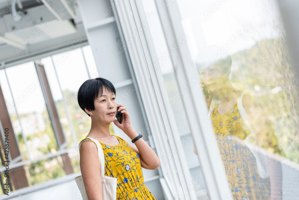 Canvas Prints mature asian woman talk on cellphone