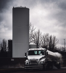 Sioux Falls, South Dakota, USA:  3-2021:  Liquid oxygen being unloaded from a semi truck into...