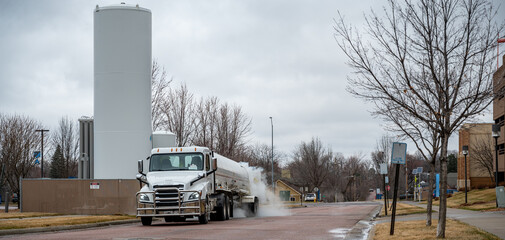 Sioux Falls, South Dakota, USA:  3-2021:  Liquid oxygen being unloaded from a semi truck into...