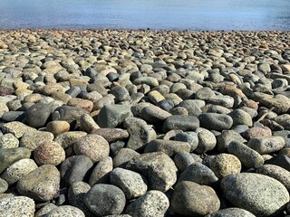 Cool background pebbles/ stones on the beach when the sea is clam.