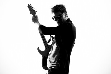 Cheerful male musician in leather jacket with sunglasses guitar performing