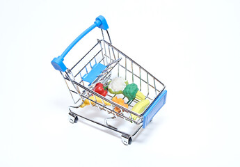 Mini cart from a supermarket with products on a white background. Top view.