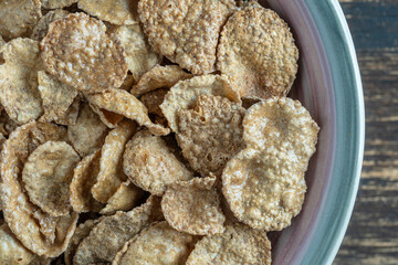 Whole grain glazed flakes in plate. Healthy breakfast, whole grain muesli in a bowl