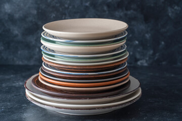 Many empty plate on black background, close up