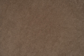 Natural fabric of brown color. Close-up long and wide texture of natural fabric. Fabric texture of natural cotton or linen textile material