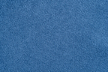 Blue texture of fabric from a textile material for an abstract background for an empty surface and for wall-paper