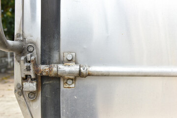 a close up of car container lockable system, old and rusty container lock system