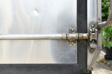 a close up of car container lockable system, old and rusty container lock system