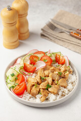 Chicken breast grill with rice and vegetables on a plate on the table. Diet nutrition.