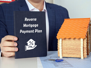  Reverse Mortgage Payment Plan inscription on dark blue book